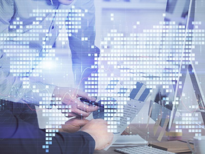 Double exposure of businessman working on laptop on background. International business hologram in front. Concept of success.